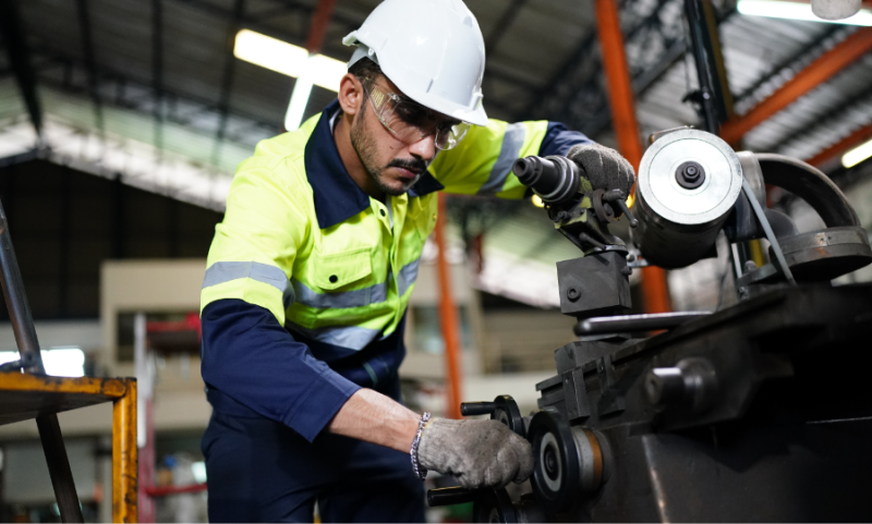 Man in safety gear operating a machine