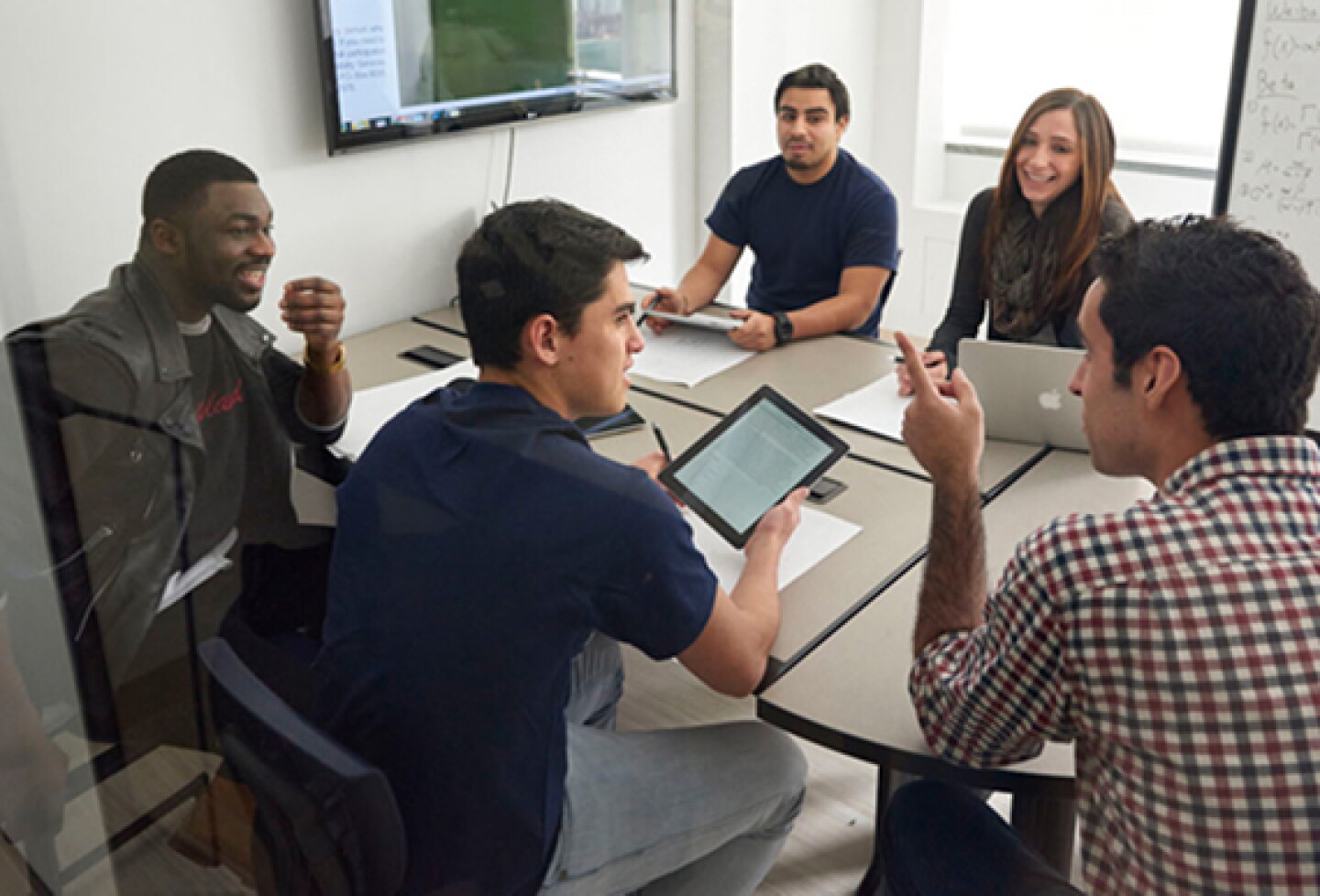 Group of students, in discussion over a table