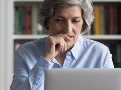 Senior female professor addressing her students in an online program.jpg