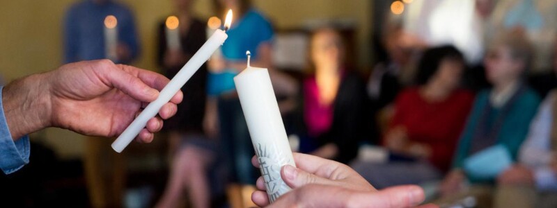 Lighting candles during a prayer service.