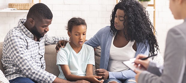 family sitting in counselor's office
