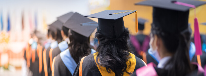 graduates walking to collect diploma