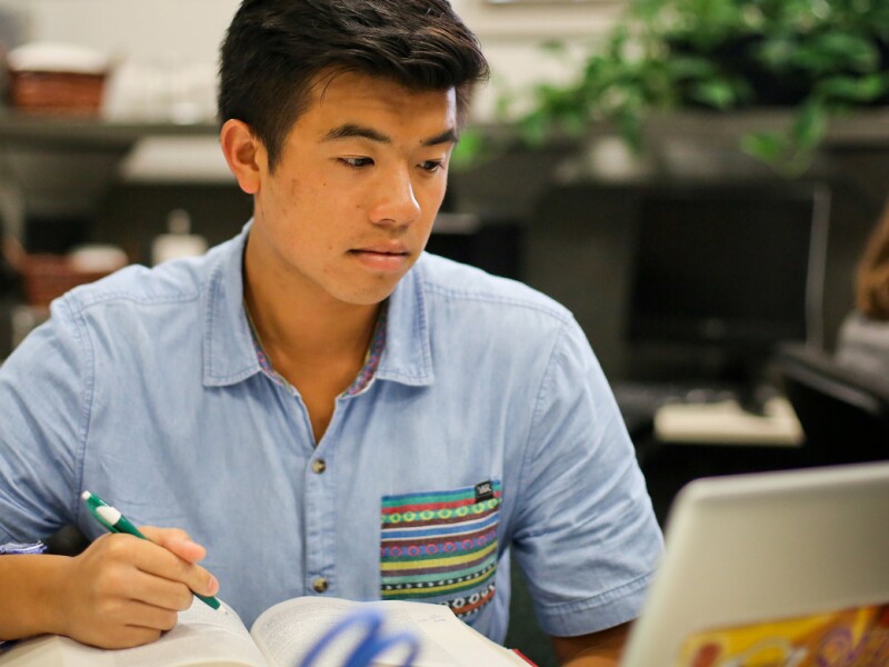 Male student working on his laptop