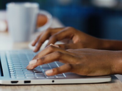 MBA recommendation letter writer typing out a recommendation letter on a laptop.