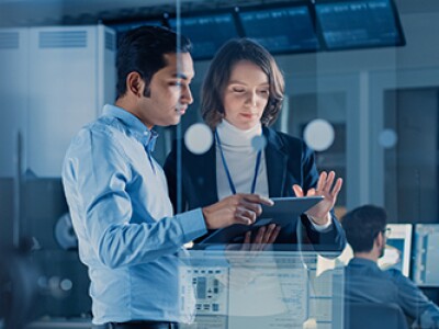 Man-And-Woman-On-Tablet-Checking-Cybersecurity