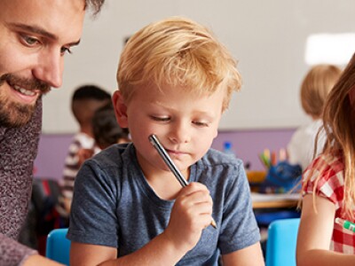 Man with boy and girl in classroom