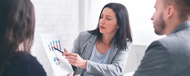 A financial planner gives a presentation to a pair of clients