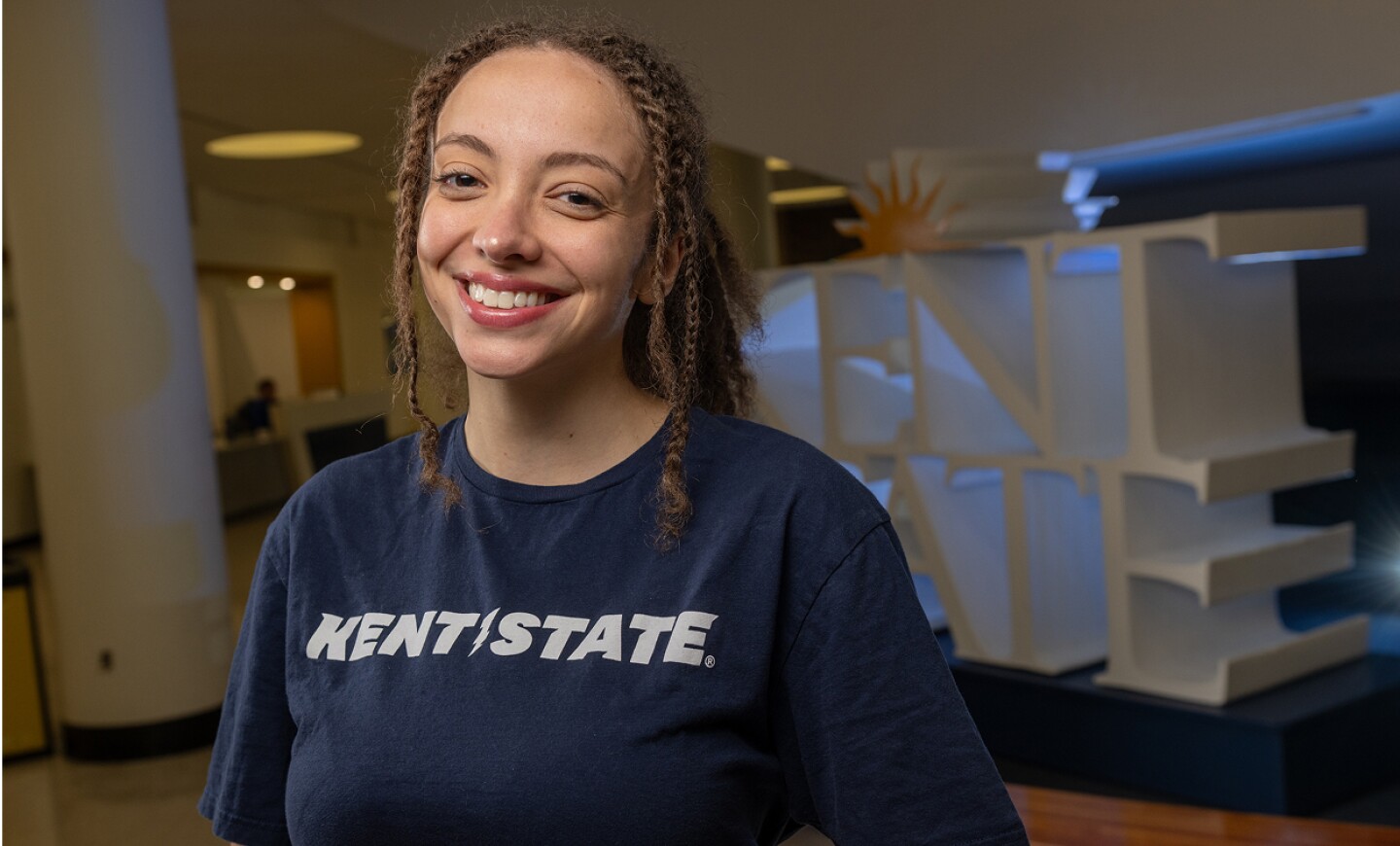 Smiling student wearing a Kent State shirt