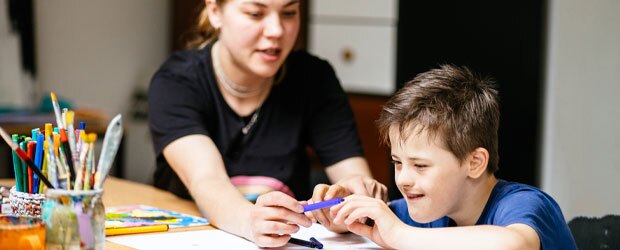 A special education teacher instructs a student.