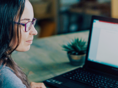 brunette-woman-at-laptop-in-glasses-succulent-next-to-computer