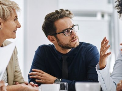 Shot of a group of businesspeople sitting together in a meeting.
