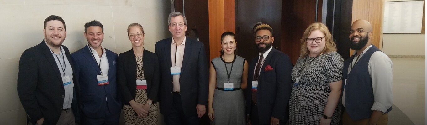 students, faculty, and speakers pose for photo at a Cardozo Law event