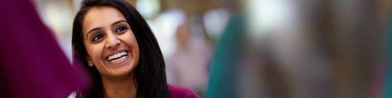 Woman of color front facing and smiling