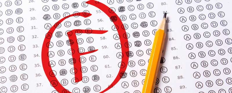 Failing grade is written with red pen on a test