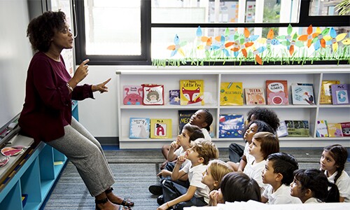 Female teacher talking to elementary students