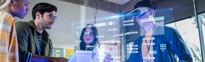 Four students using virtual reality equipment and software experiencing a virtual environment