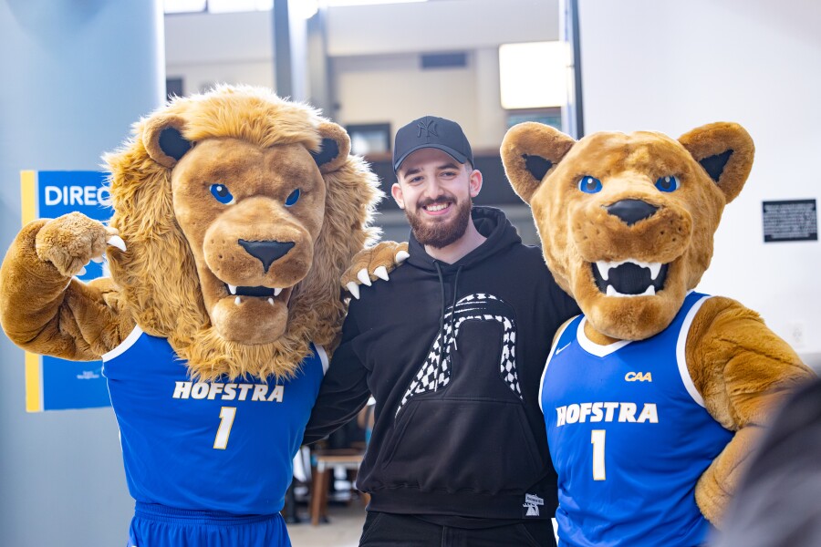 student with Hofstra mascots