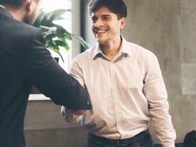 Young professional is congratulated on job promotion