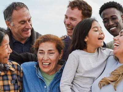 Candid shot of a multiracial, multigenerational family laughing together