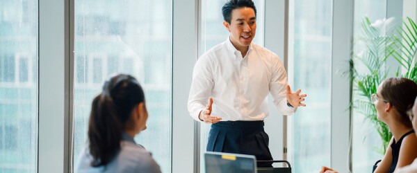 renewable energy executive speaks to team in conference room