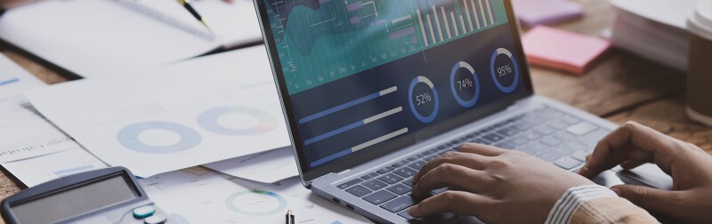 Desk with laptop showing a financial dashboard tool.