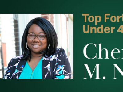 Cherise M. Newsome, MBA ‘23 Candidate,, smiles while enjoying a beautiful day at a cafe patio.