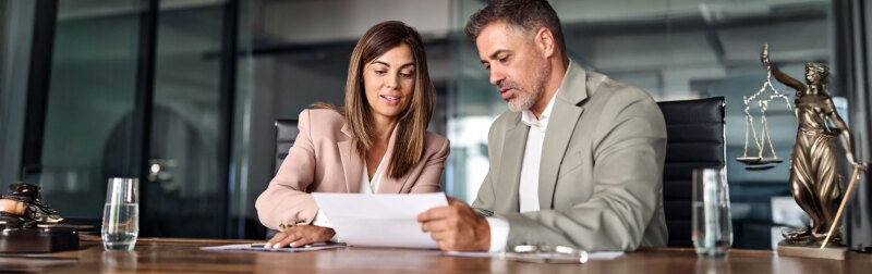 Two people looking over a document.