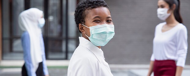 Happy woman wearing face mask, social distancing