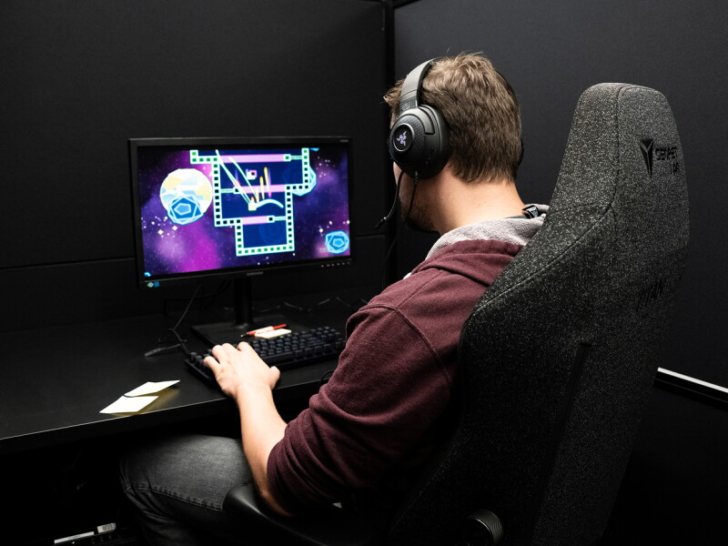 Man wearing headphones at a computer.