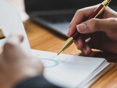 Man working on paperwork, analyzing financial statements
