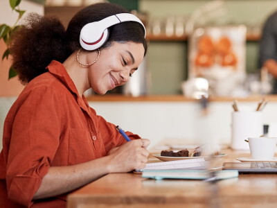 Woman, student in cafe working on personal statement for online MBA application