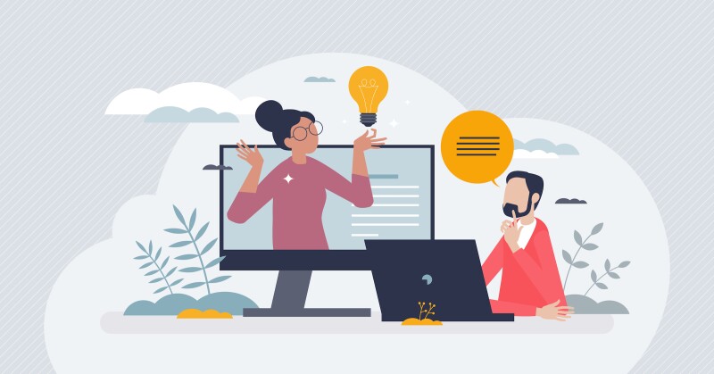 A person using a laptop and reviewing a presentation on another screen