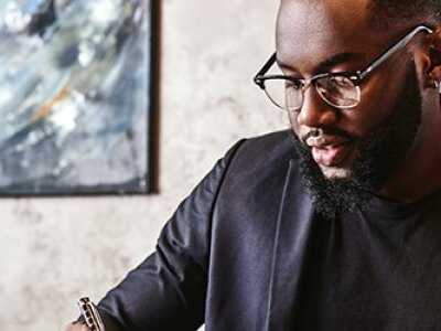 African American male studying on laptop