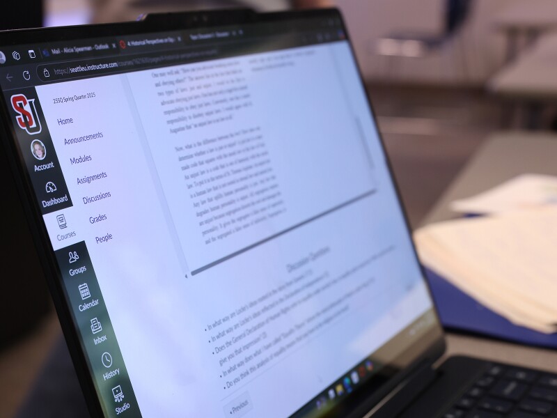 Laptop displaying content on the Seattle University online learning site