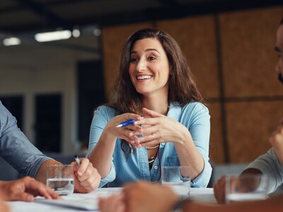 Woman leading a meeting in an open plan office