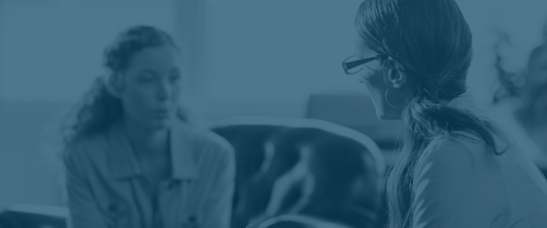 Female counselor speaking with young female client