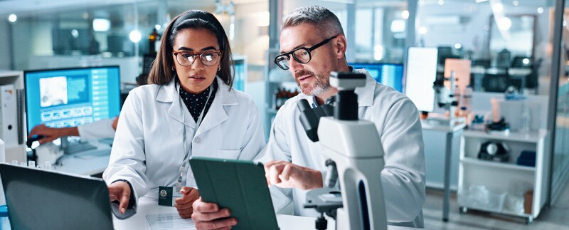 Two people in lab together conducting research
