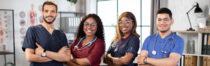Diverse multiethnic cheerful medical team at work in hospital.