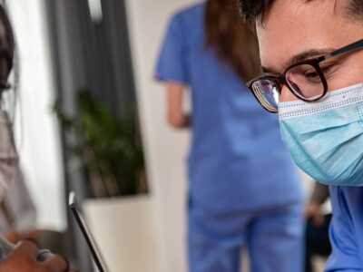 Nurse administering vaccine in patients arms
