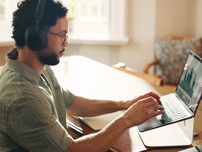 Man at home reviewing an analytics dashboard on his laptop