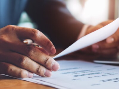 man-in-suit-filling-out-a-resume