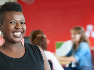 Confident woman working in red creative office space
