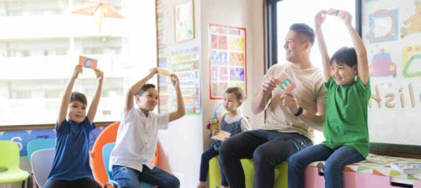 teacher-helping-young-students-learn-a-new-language