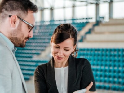Professionals look over paperwork in sports complex