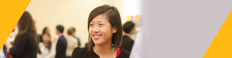 Woman smiles confidently at networking event