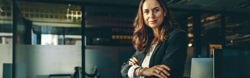 Mature businesswoman sitting on her desk