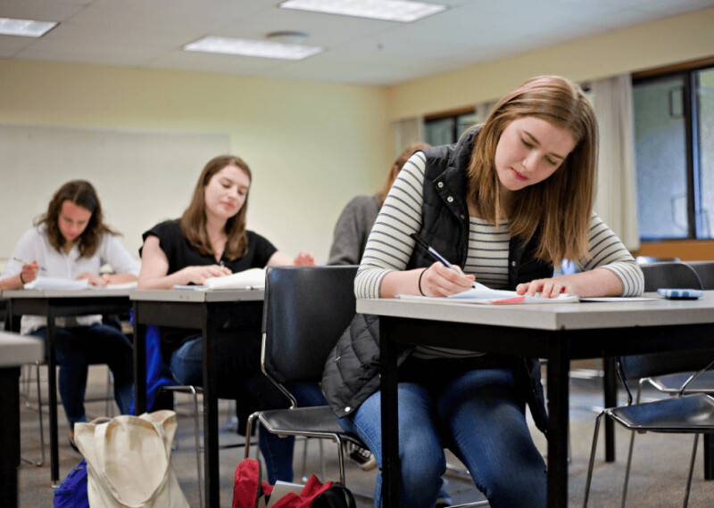 Students taking an entrance exam in a classroom