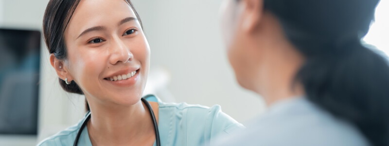 A nurse listens carefully to a patient.