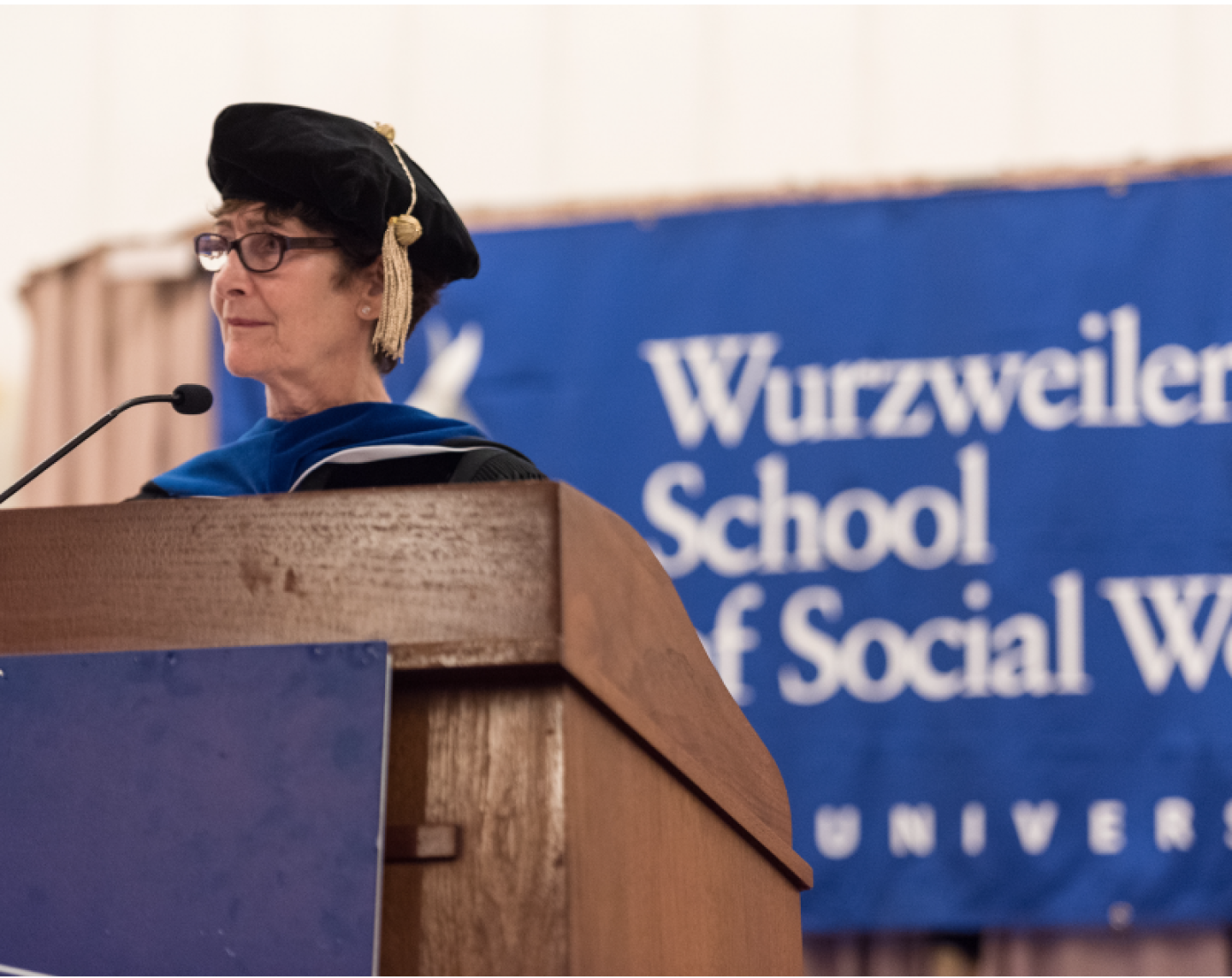 Wuzweiler-Faculty-Members-Speaks-At-Podium