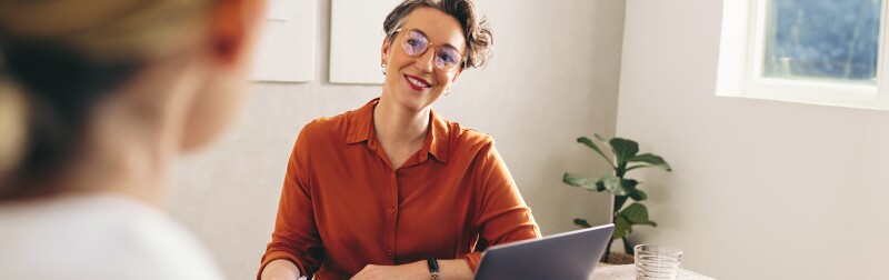 Hiring manager interviewing a job candidate in her office